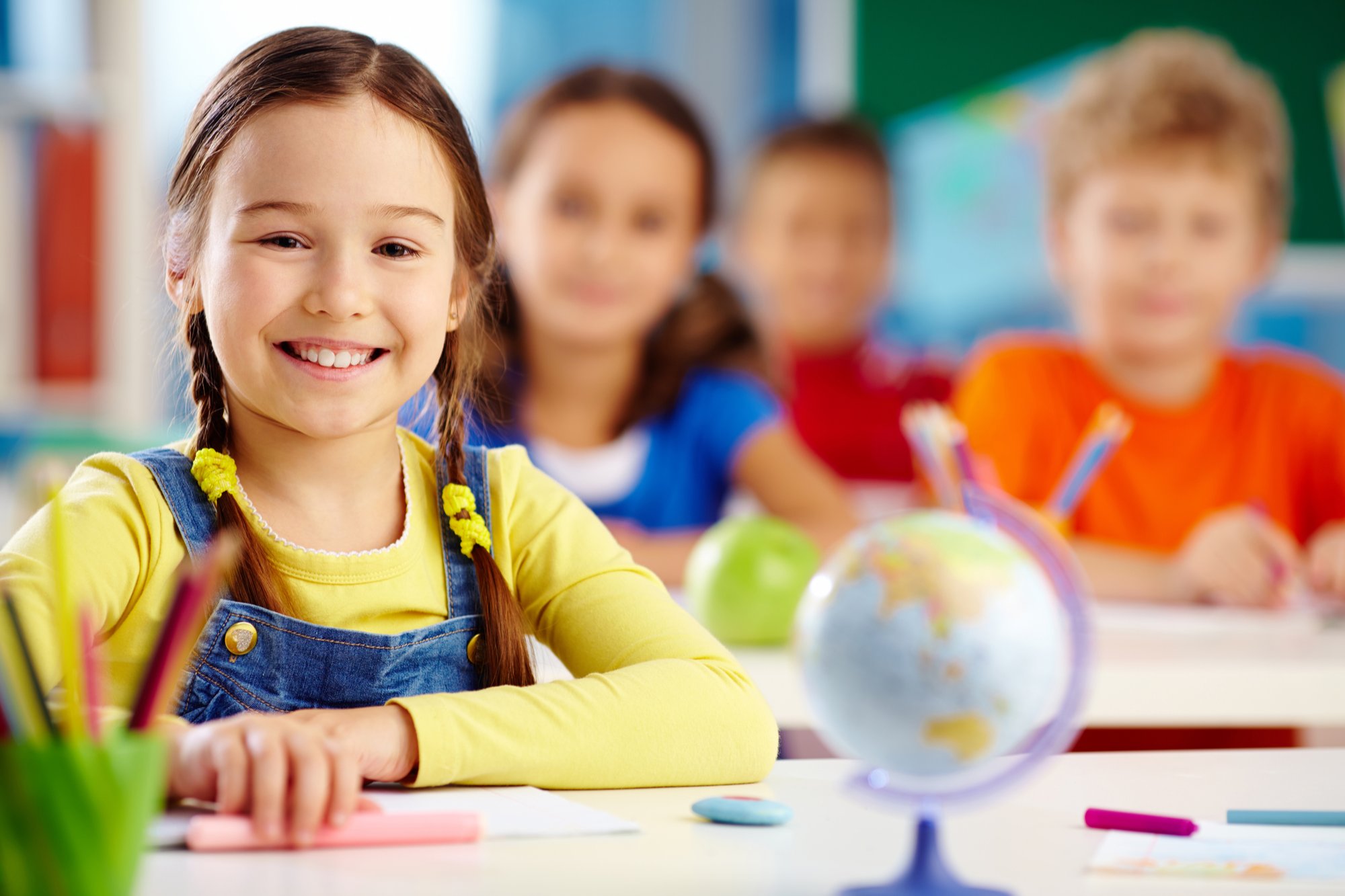 Kanak-kanak sedang belajar dan menyediakan tugasan di sekolah dengan gurunya.
