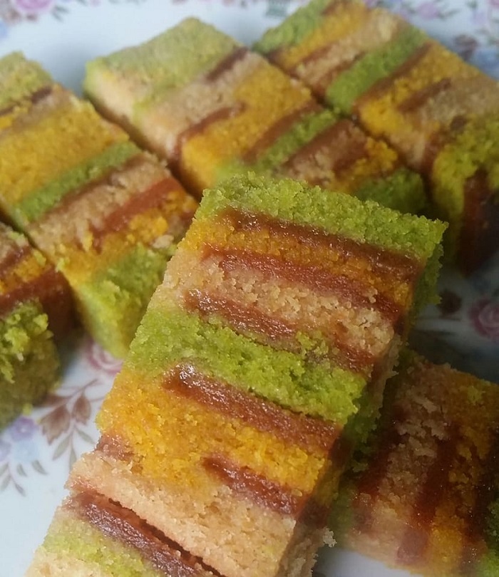 Kek Lapis Sarawak berlapis warna kuning dan hijau dengan haw flakes dipotang rapi untuk dihidangkan