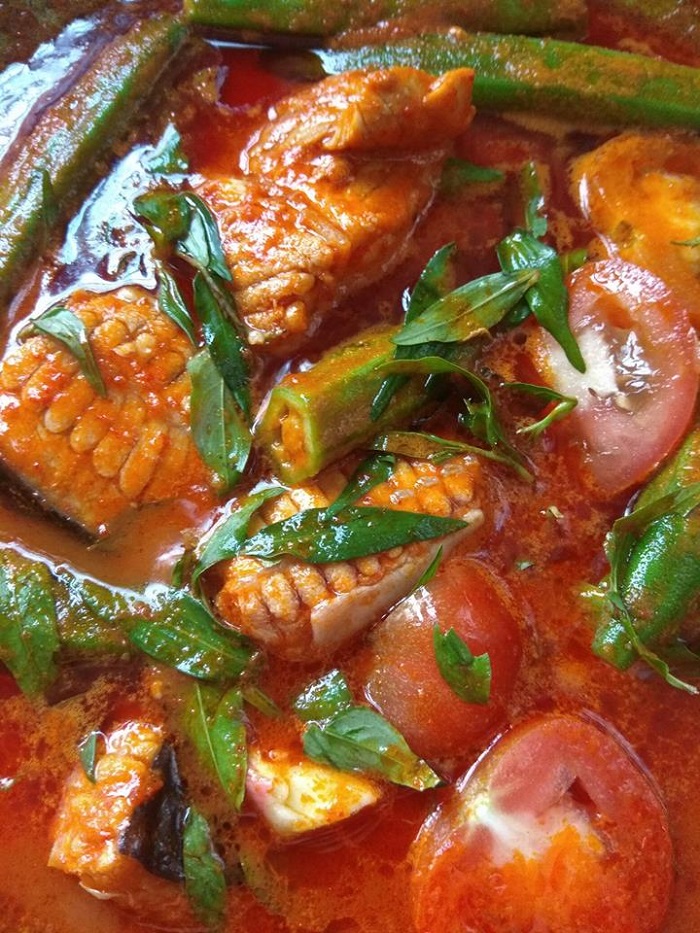 Sepinggan mangkuk asam pedas ikan pari dengan kuah merah pedas beserta sayuran dan tomato.