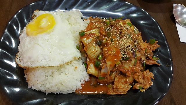 Gambar sepinggan nasi putih sedang dimakan menggunakan sudu