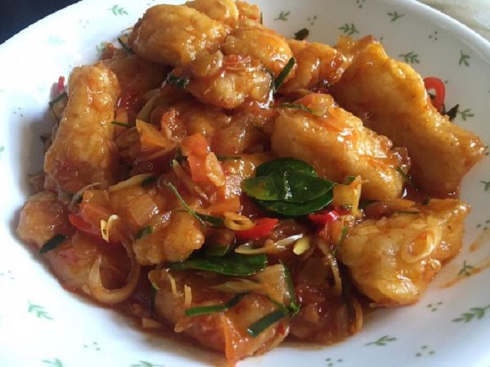 Pinggan hidangan fillet ikan goreng bersalut tepung rangup bersama sos yang menyelerakan.