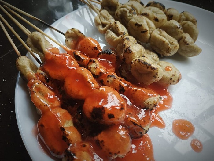 Sepinggan lokching atau satay ikan yang telah siap digoreng dan dibakar beserta sos cicah merah.