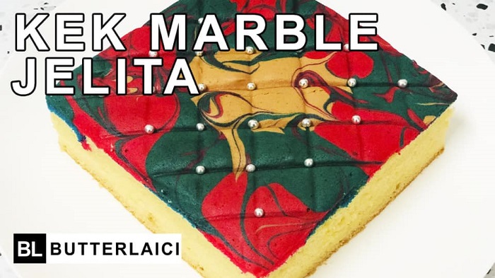 Kek Marble Jelita yang cantik dengan tekstur marmar dan hiasan manik di atas permukaan.