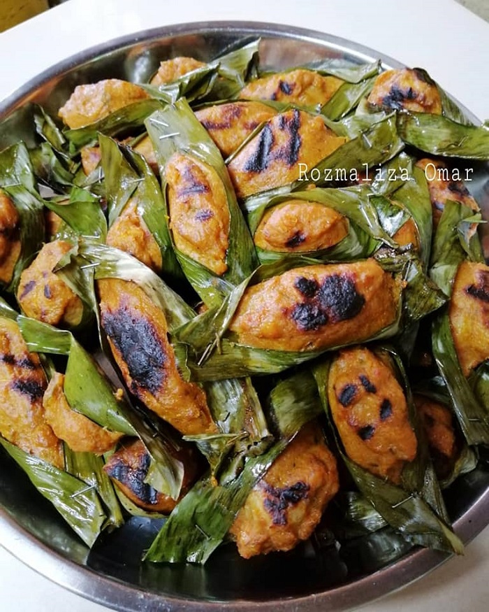 Otak-otak ayam dibungkus dengan daun pisang yang sudah siap dimasak.
