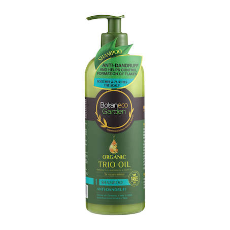 Pelbagai botol syampu organik untuk merawat rambut gugur disusun bersama daun herba semulajadi.
